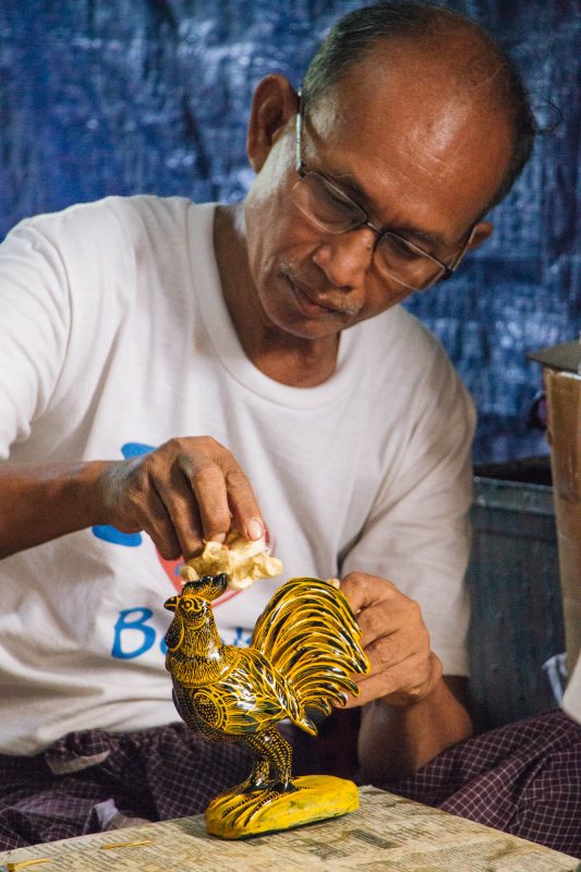 Artisan applying gold leaf