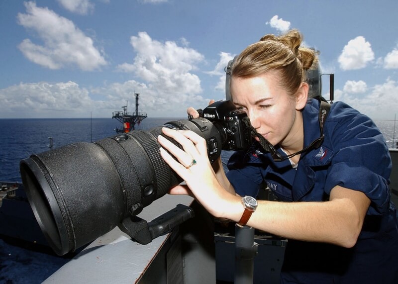 US Navy member Sabrina Day uses this giant 400mm fixed telephoto lens aboard an aircraft carrier.